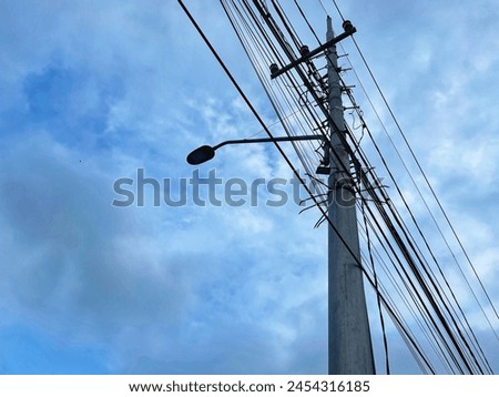 power pole or tiang listrik. Towering through the clouds Royalty-Free Stock Photo #2454316185