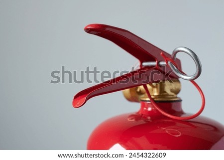fire extinguisher on a gray background, close-up, macro