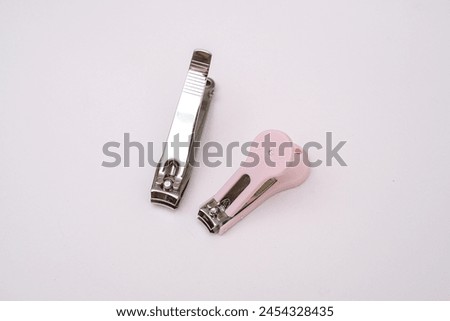 A couple of nail cutters on a white background