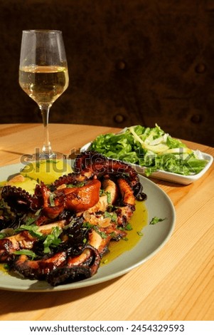 A classic Portuguese dish, "Polvo à Lagareiro," featuring tender octopus with roasted potatoes, garlic, and olive oil. It's presented on a rustic plate, accompanied by a glass of Alentejo white wine. 