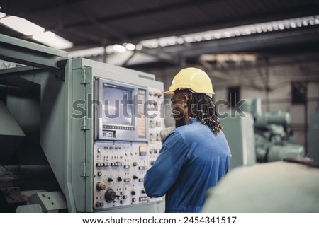 Technician conduct troubleshooting, modify settings, activate processes, and operate machines in a factory facility. Maintenance and regulates the performance of the machine using real-time data. Royalty-Free Stock Photo #2454341517