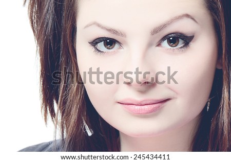 Close-up portrait of a young beautiful lady on white background. Toned and filtered photo
