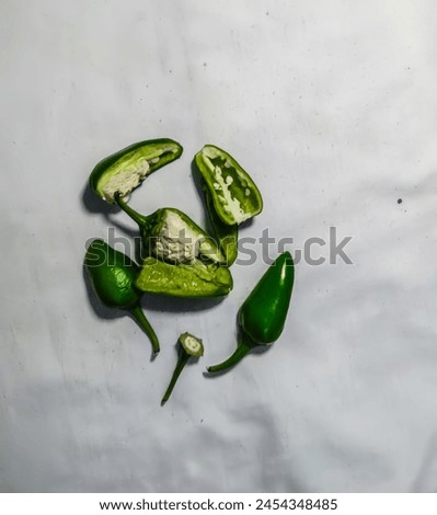 "Fresh green chilies, chopped into whole and sliced pieces, ready to add a spicy kick to your dish.Enhance the flavor and heat of your recipes with these finely chopped green chilies."