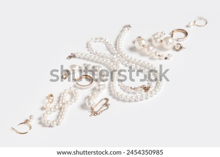 Beautiful composition with pearl bijouterie on white background