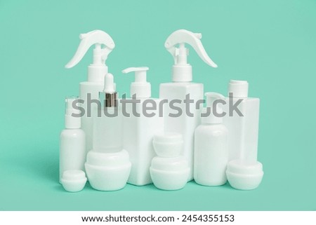 Different cosmetic products on green background