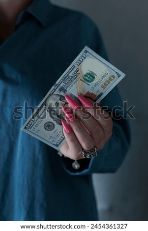 female hands holding American dollar paper bills