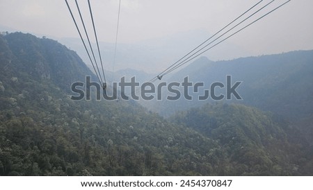 View of Fansipan mountain, Sapa town, Vietnam in the morning with foggy. The cable of aerial tramway and. Picture  adventure landscape. 