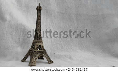 Miniature Eiffel Tower Statue on White Background
A close-up photo of a decorative miniature Eiffel Tower statue on a crisp white background. Perfect for home decor, a gift, or a souvenir.