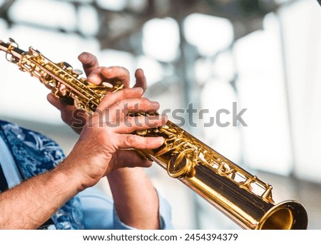 close-up of the hands of a musician playing the soprano saxophone Royalty-Free Stock Photo #2454394379