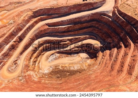 Cobar copper mine open pit excavated deep whole in the ground of NSW, Australia - aerial top down. Royalty-Free Stock Photo #2454395797