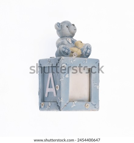 children photo frame with bear toy isolated on white background