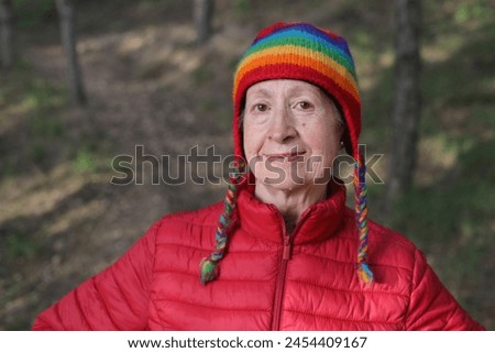 Mature woman walking in the park during winter time
