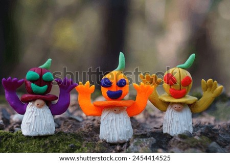 Figures of dwarfs decorated with pumpkin. Halloween decorations.