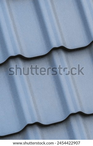 It's the photo of grey and roof tiles. It is close up view of colorful tiles. It's view of multicolored roof. It is texture of tiles.