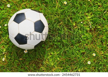 A soccer ball over a green grass field