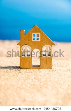 The symbol of the house standing on the seashore
