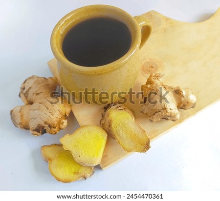 Black Coffee with ginger root and fresh ginger slice on wooden board.