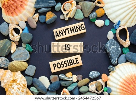 Anything is possible symbol. Concept words Anything is possible on beautiful wooden blocks. Beautiful black table black background. Sea shell stone. Business anything possible concept. Copy space.