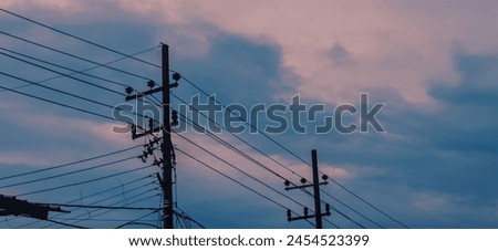Power Lines Against Dramatic Storm Clouds