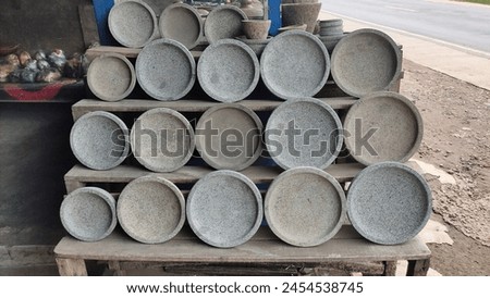 Mortar and Pestles Arranged in a Row on Wooden Rack. A set of mortar and pestles, traditional tools used for grinding ingredients, arranged in a row on a wooden rack. Royalty-Free Stock Photo #2454538745