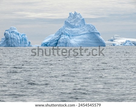 Antarctica Penguins Ice Fjords Snowcapped Mountains Royalty-Free Stock Photo #2454545579