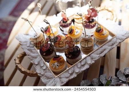 Delectable mini pancakes on mirrored tray, perfect for catering events. Bite-sized treats to tantalize taste buds  elevate events. Royalty-Free Stock Photo #2454554503