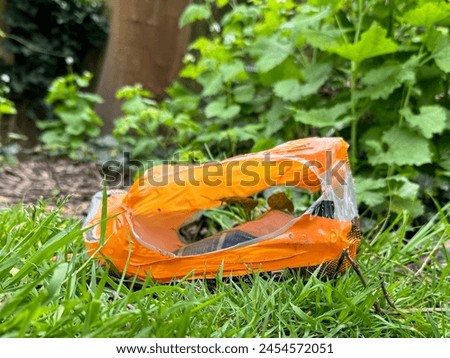 Plastic waste thrown away in the undergrowth. Royalty-Free Stock Photo #2454572051