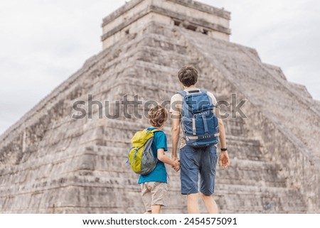 Father and son tourists observing the old pyramid and temple of the castle of the Mayan architecture known as Chichen Itza these are the ruins of this ancient pre-columbian civilization and part of Royalty-Free Stock Photo #2454575091