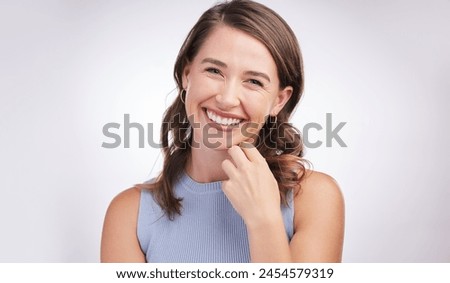 Woman, laughing and portrait in white studio background with confidence for student, college or university in Canada. Female person, smile or enjoy joke for campus, learn or higher education Royalty-Free Stock Photo #2454579319