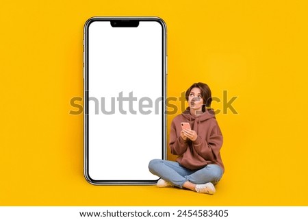 Full size photo of young thinking charming girl bob brown hair use phone look display hmm web store isolated on yellow color background