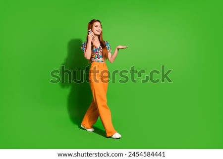 Photo portrait of attractive young woman walk talk phone dressed stylish retro clothes isolated on green color background