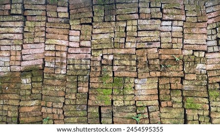 Mossy stone wall texture, vintage weathered mossy wall background Royalty-Free Stock Photo #2454595355