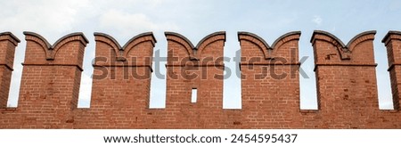 View of a fragment of the battlements of the fortress wall. Battlements of the upper part of the Kremlin fortress wall. Russia, Kremlin Royalty-Free Stock Photo #2454595437