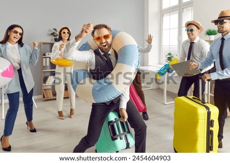 Lively office colleagues is eagerly awaiting approach of summer vacation season. Colleagues with accessories for beach holiday are ready for well-deserved rest from hustle and bustle of corporate life Royalty-Free Stock Photo #2454604903