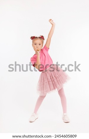 Happy and cute girl in party hat celebrating birthday with present and have a fun on white background. happy childhood  