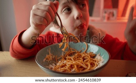 Young Child Delighting in Spaghetti Dinner, 5-Year-Old Boy's Meal Enjoyment, Close-Up of Happy Pasta Eating Experience 480p.m Royalty-Free Stock Photo #2454610839