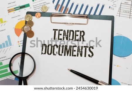 TENDER DOCUMENTS. text on an open notebook on an envelope with money