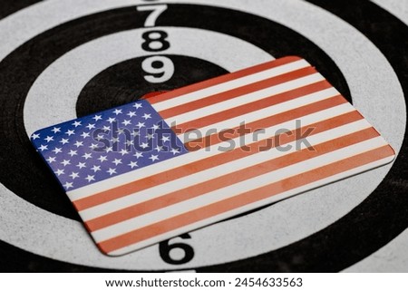 Small American flag against the backdrop of a darts target