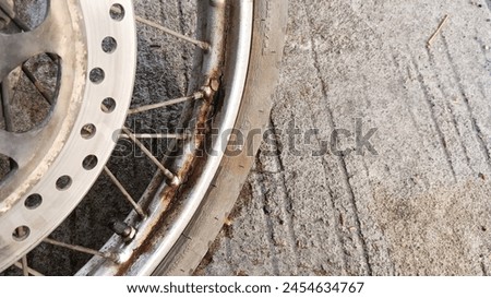 Close up of a rusty motorbike front wheel