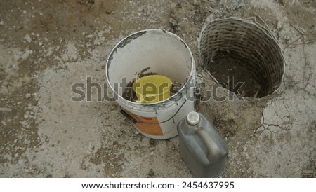 Grobogan, Central Java, Indonesia - Empty Bucket Impact of Prolonged Drought in Central Java, Bad Environment Issue  Royalty-Free Stock Photo #2454637995
