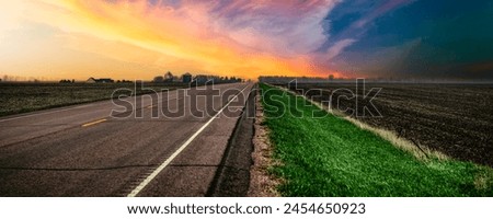 South Dakota Stormy Sunset on the rural road and the agricultural field in Lincoln County, a beautiful landscape of the American Heartland of the Upper Midwest, USA Royalty-Free Stock Photo #2454650923