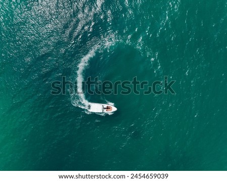 Aerial view of Speed boat in the aqua sea making a circle, Drone view. Royalty-Free Stock Photo #2454659039