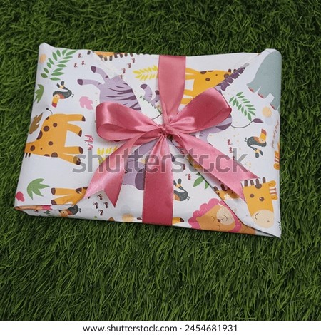 Small Gifts Wrapped In Wrapping Paper (With Pictures Of Animals) And Ribbons For Children