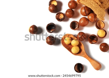 Peeled macadamia nuts in wood spoonl isolated on white background, Macadamia nuts are loaded with flavonoids and tocotrienols and rich in heart-healthy monounsaturated fats Royalty-Free Stock Photo #2454699795
