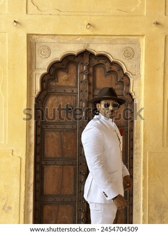graceful man showcases cultural elegance in traditional attire, exuding confidence and heritage in a single pose Royalty-Free Stock Photo #2454704509