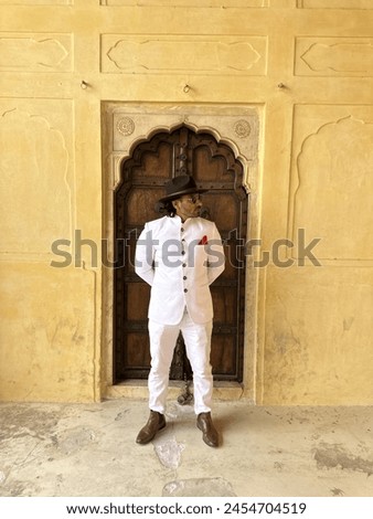 graceful man showcases cultural elegance in traditional attire, exuding confidence and heritage in a single pose Royalty-Free Stock Photo #2454704519