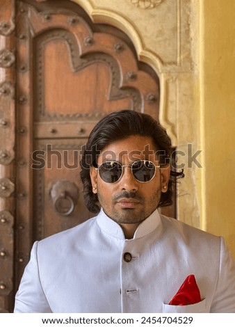 graceful man showcases cultural elegance in traditional attire, exuding confidence and heritage in a single pose Royalty-Free Stock Photo #2454704529