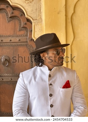 graceful man showcases cultural elegance in traditional attire, exuding confidence and heritage in a single pose Royalty-Free Stock Photo #2454704533