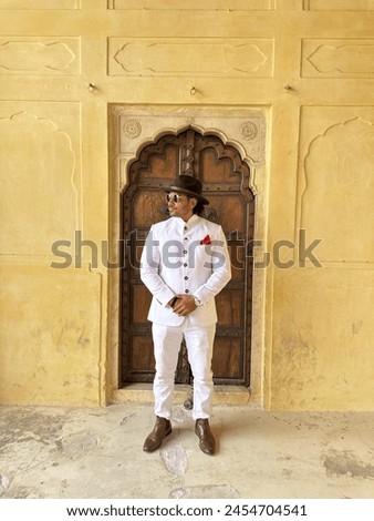 graceful man showcases cultural elegance in traditional attire, exuding confidence and heritage in a single pose Royalty-Free Stock Photo #2454704541