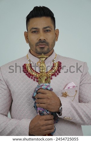 Man exudes grace and heritage in traditional attire, capturing timeless elegance and cultural pride in a single pose Royalty-Free Stock Photo #2454725055